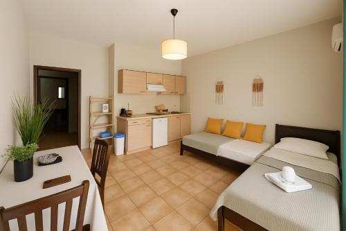 a room with a bed and a kitchen with a table at Nicolas Beach in Palaiochora
