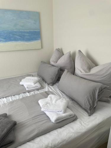 a white bed with pillows and towels on it at Ferienwohnung Steubenhöft in Cuxhaven