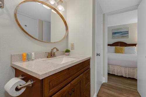 a bathroom with a sink and a mirror and a bed at Impressive 1Br Oceanfront Suite, Dogs OK! 1006 in Myrtle Beach