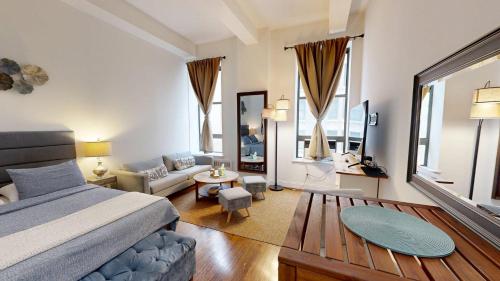 a bedroom with a bed and a living room at Nomad stylish studio in NYC in New York