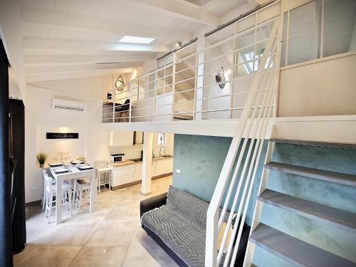 a small apartment with a spiral staircase in a room at La 34 Tiny House with sunny terrace in Menton