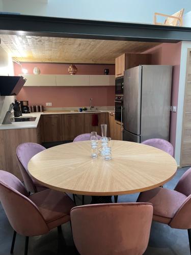 une cuisine avec une table en bois et des chaises violettes dans l'établissement Appartement centre préfecture, à Lyon