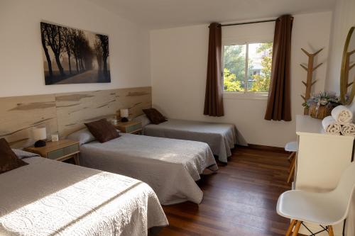 a room with two beds and two windows at Dalt Vila Salou Deluxe in Salou
