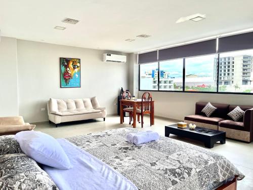a bedroom with a bed and a living room at Edificio El Navío Luxury Suite 702 in Manta