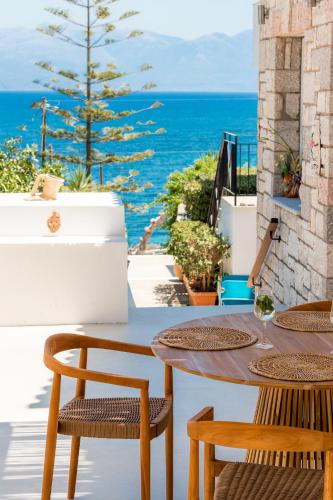 a table and chairs with a view of the ocean at Pelagia Apartments in Koroni