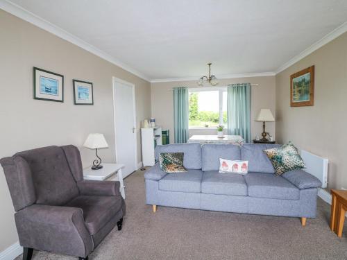 a living room with a couch and a chair at Findale in Wexford
