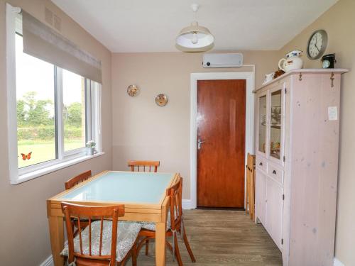 a dining room with a table and chairs at Findale in Wexford