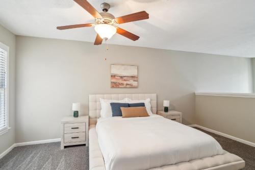 a bedroom with a white bed with a ceiling fan at Spacious 1 Bed 15 Bath Towmhome I Ellenwood in Ellenwood