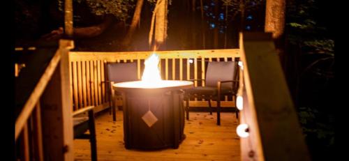 a light on a porch with chairs and a table at Dreaming Tree Cabin in Pigeon Forge