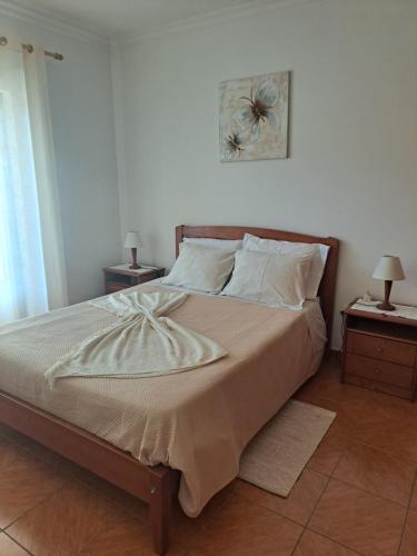 a bedroom with a large bed with two night stands at Casa Barbara in Lagos