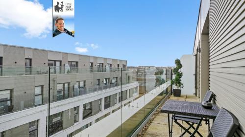 a table on the balcony of a building at 1 Bedroom Penthouse Apartment By Littlepiggyrentals Short Lets & Serviced Accommodation Stevenage With Balcony & Fast WiFi in Stevenage