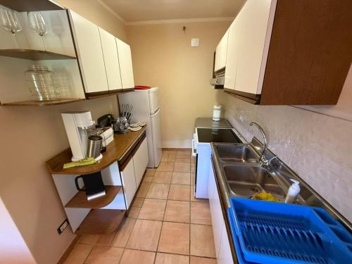 a small kitchen with white cabinets and a sink at Il Mulin Dell'Architetto in Fornaci di Barga