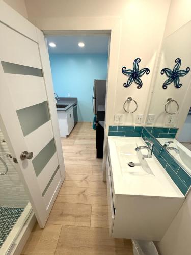 a bathroom with a sink and a mirror at CasaViva Sol - Modern Pet-Friendly Studio with Patio & Shared Yard - Walk to Eats & Coffee, 5 Min to Gaslamp & Beaches in San Diego