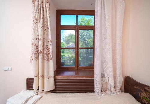 a bedroom with a window with curtains at Holiday Home Ruben in Odzun