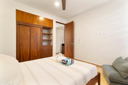 a bedroom with a bed and a couch at Tropical getaway in Tulum with private pool in Tulum