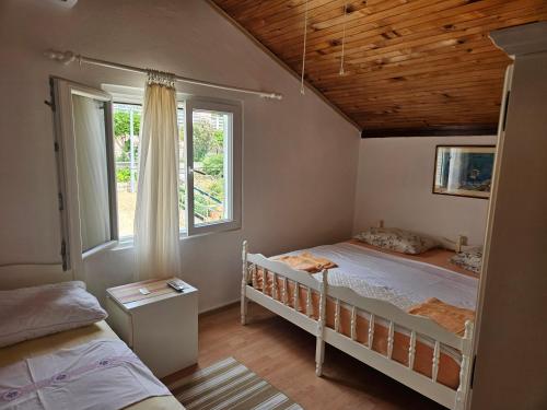 a bedroom with two bunk beds and a window at Apartment Zdenka in Dinjiška