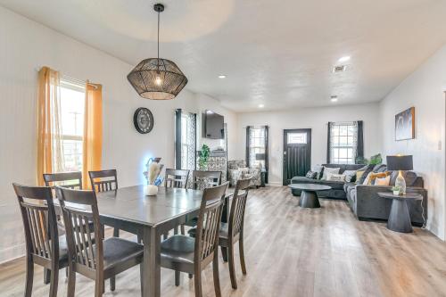 a dining room and living room with a table and chairs at Backyard Movie Nights! Galveston Beach Retreat in Galveston