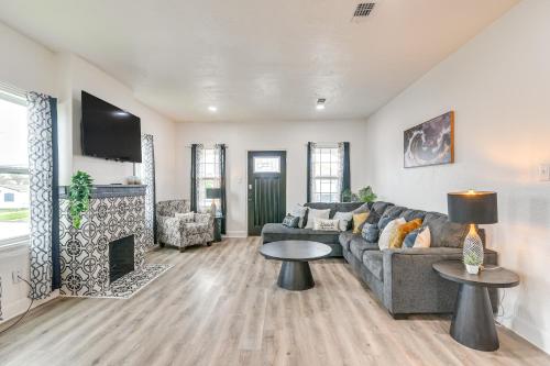 a living room with a couch and a fireplace at Backyard Movie Nights! Galveston Beach Retreat in Galveston