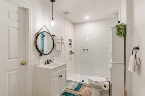 a white bathroom with a sink and a mirror at Backyard Movie Nights! Galveston Beach Retreat in Galveston