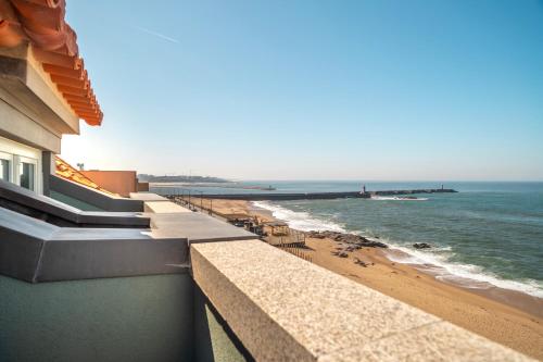 a view of the beach from the balcony of a building at EDiTiON 147 - Luxury Housing in Porto