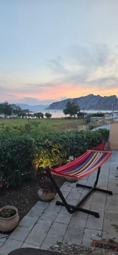 a hammock on a patio with a view of the ocean at Perivleptos ΙI in Perdhika