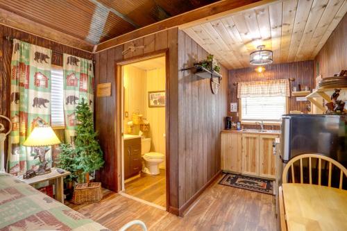 a room with a bathroom and a kitchen with wooden walls at Romantic Escape in Greers Ferry Less Than 1 Mi to Lake in Higden