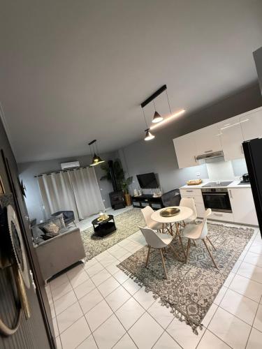 a kitchen and living room with a table and chairs at RHODESIA guest house in Chalkida