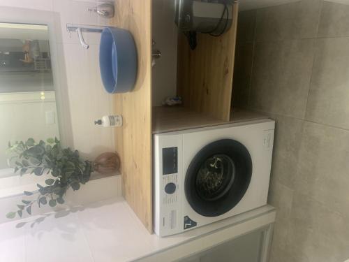 a washing machine sitting on a counter in a bathroom at Tres dormitorios ,vistas al mar , junto a la playa in Punta Umbría