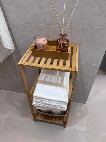 a bamboo shelf with towels on it in a bathroom at Apartamento Boutique Valencia 4-Pax - B-2 in Valencia