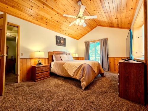 a bedroom with a bed and a ceiling fan at 3BR Home w Game Room by The Village, Lake & Summit in Big Bear Lake