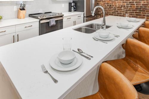 a kitchen with a counter with plates and utensils on it at The Saddlery - Key Note - Walk to Broadway in Nashville