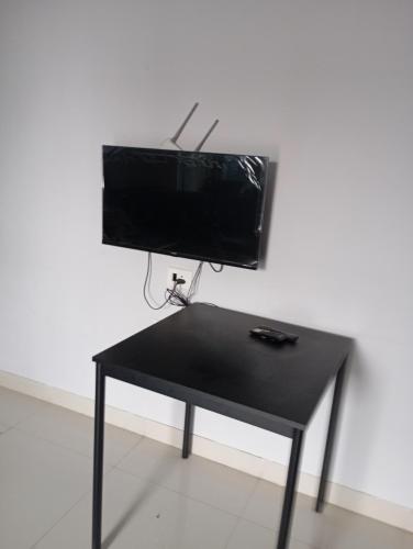 a black table with a television on top of it at Pimple Saudagar 2bhk in Pune