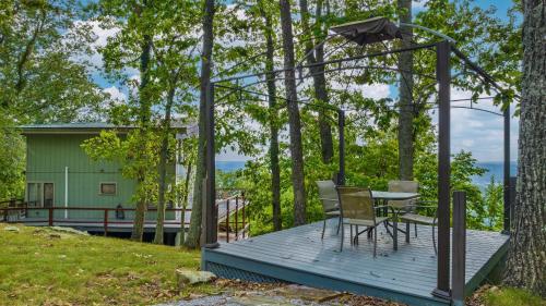 a wooden deck with a table and chairs on it at Mountain Retreat Ruby's Roost Home & Loft in Mentone