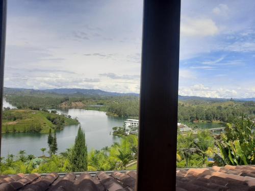 a view of a river from a window at Hotel Zocalo Campestre in Guatapé