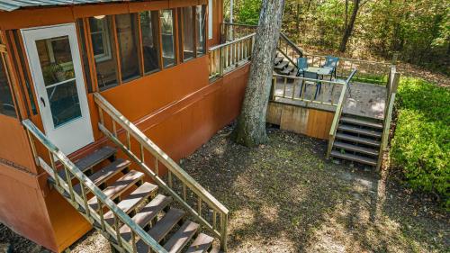 an orange house with a staircase and a tree at Downtown Mentone - Baileys Bungalow in Mentone