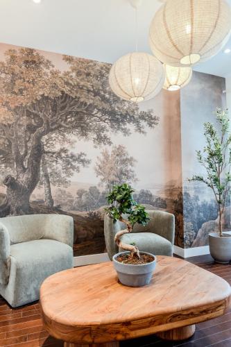 a living room with a table and two chairs and a mural at Self Check-In Boutique Hotel - Quartier latin - Room 101 in Montréal