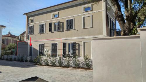 a house with a white fence in front of it at Casa CaBì in Senigallia