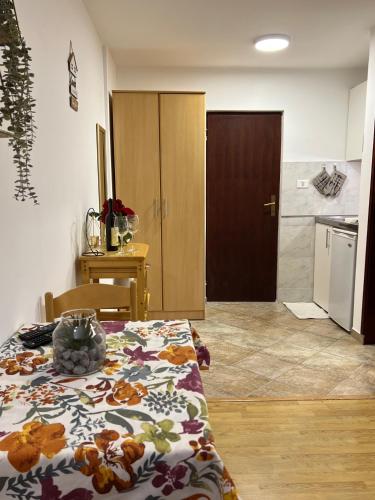 a room with a bed with a flowered blanket on it at Savo Apartments in Tivat