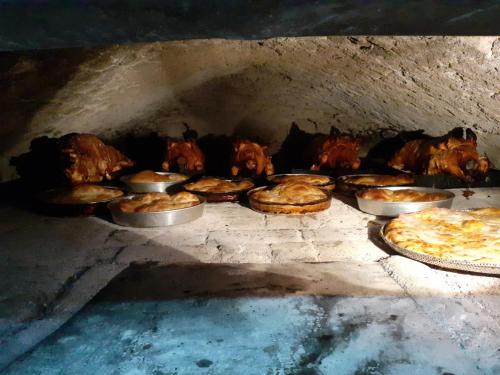 a group of pizzas are cooking in an oven at Apartmani Kovačević MKM Banja Vrujci in Gunjica