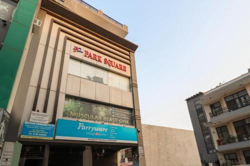 a building with a sign for a hair salon at Hotel O Cloud Stay & Cafe in Indraprast