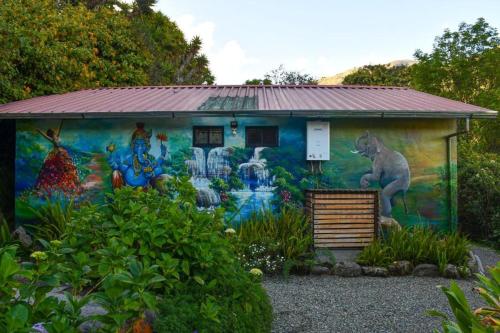 a building with a mural on the side of it at Twelve Hummingbirds Andes Retreat in Paute