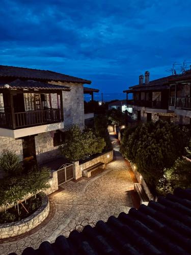 a view of a courtyard of a building at night at Your Afytos Home in Afitos
