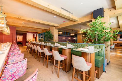 a restaurant with a long bar with chairs and tables at Home2 Suites By Hilton Chicago River North in Chicago