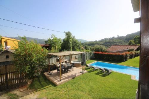 a backyard with a pool and a gazebo at Casa da Pontelha by Gerês Casas in Terras de Bouro