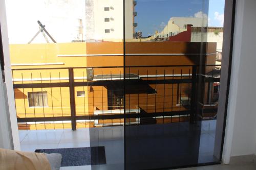 a view of a building through a glass window at Spacious Two Bedroom Two Bathroom Apartment in Downtown Asuncion in Caña de Castilla