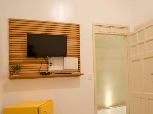 a flat screen tv on a wall in a room at Suítes Pe na Areia in Jericoacoara