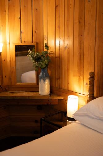 a vase of flowers on a table in a bedroom at Lake Front Cabins in June Lake