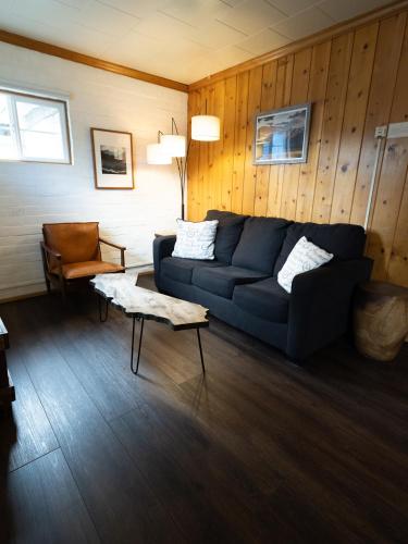 a living room with a blue couch and a chair at Lake Front Cabins in June Lake
