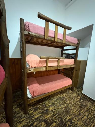 a couple of bunk beds in a room at Jujuy Hostel in San Salvador de Jujuy