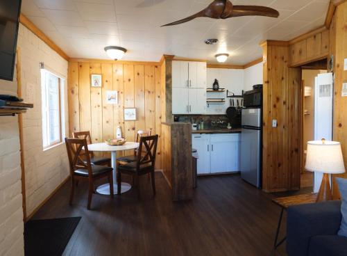 a kitchen with a table and chairs in a room at Lake Front Cabins in June Lake